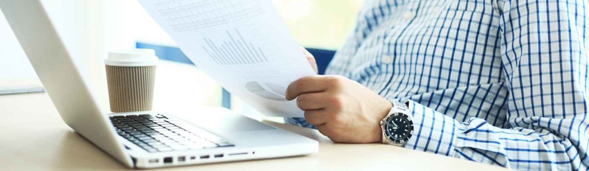 man checking his loan rates on his laptop