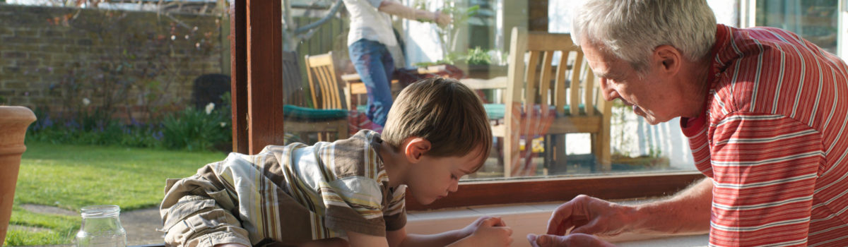 A grandfather counts change with his grandson.